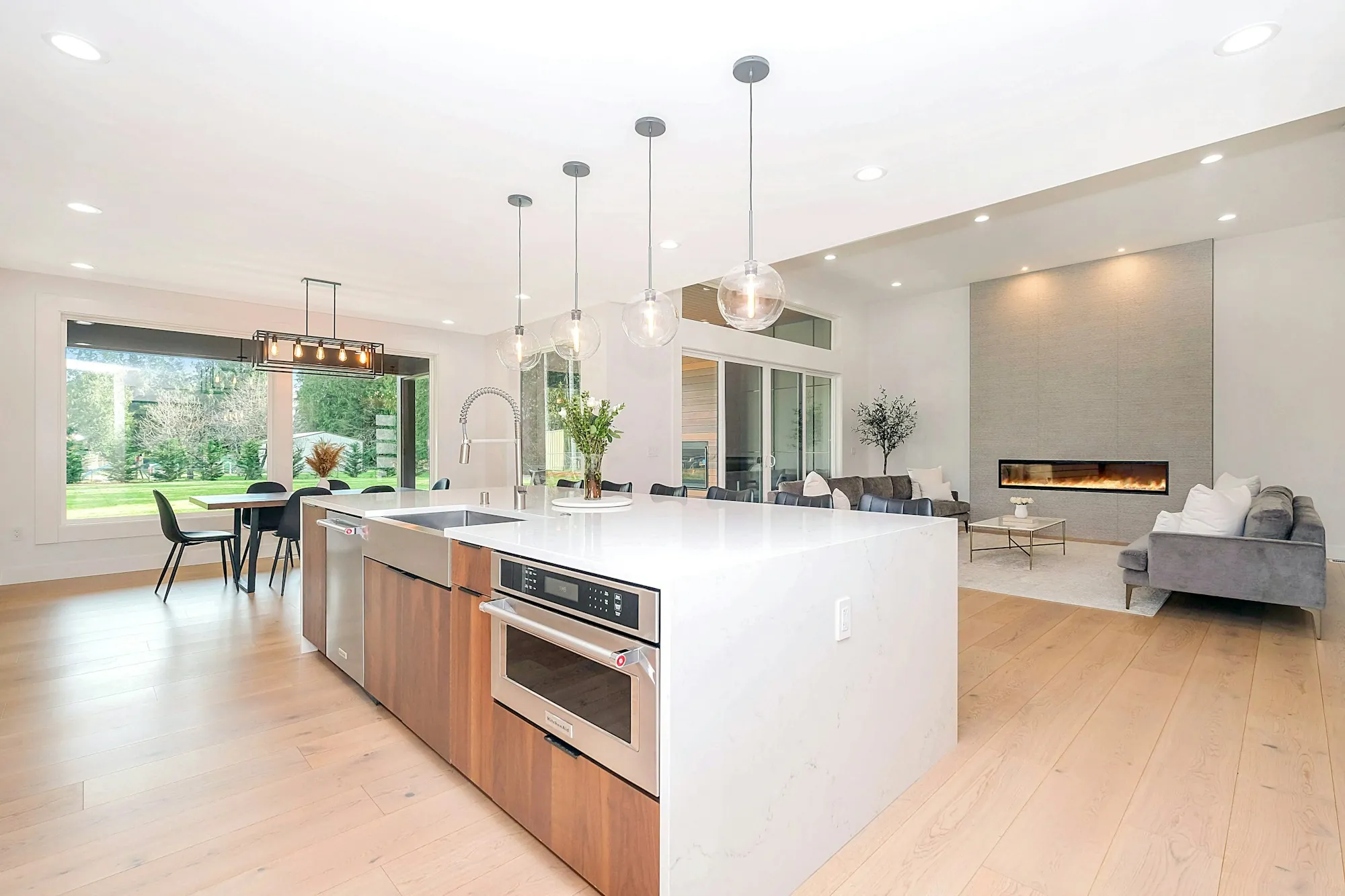 An open-plan living space lit by recessed ceiling lights