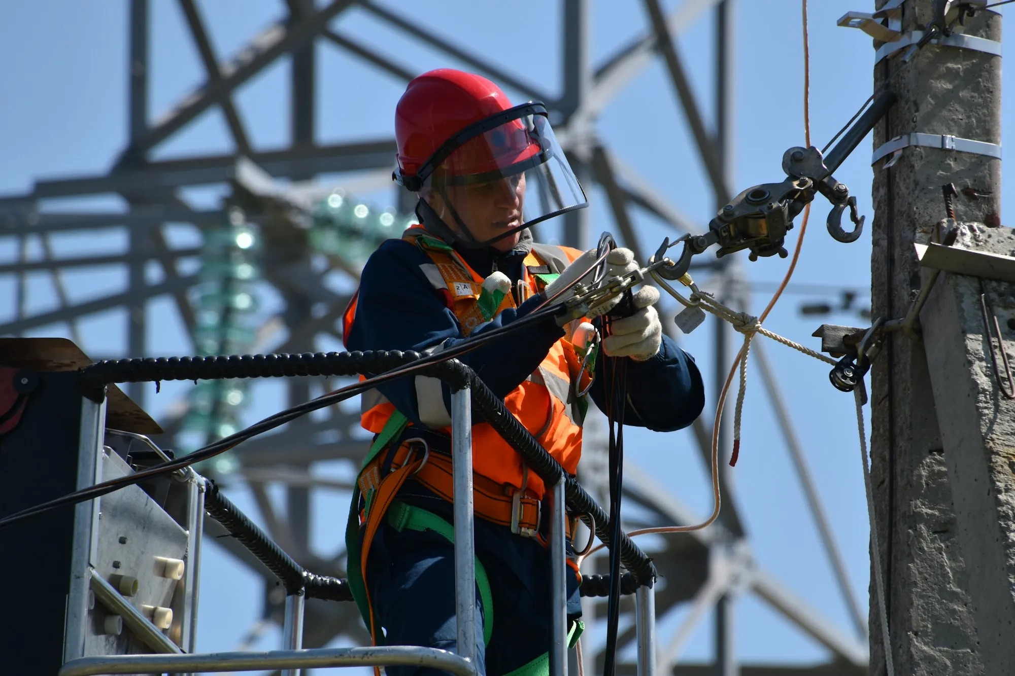 A person on a ladder working on ceiling lighting