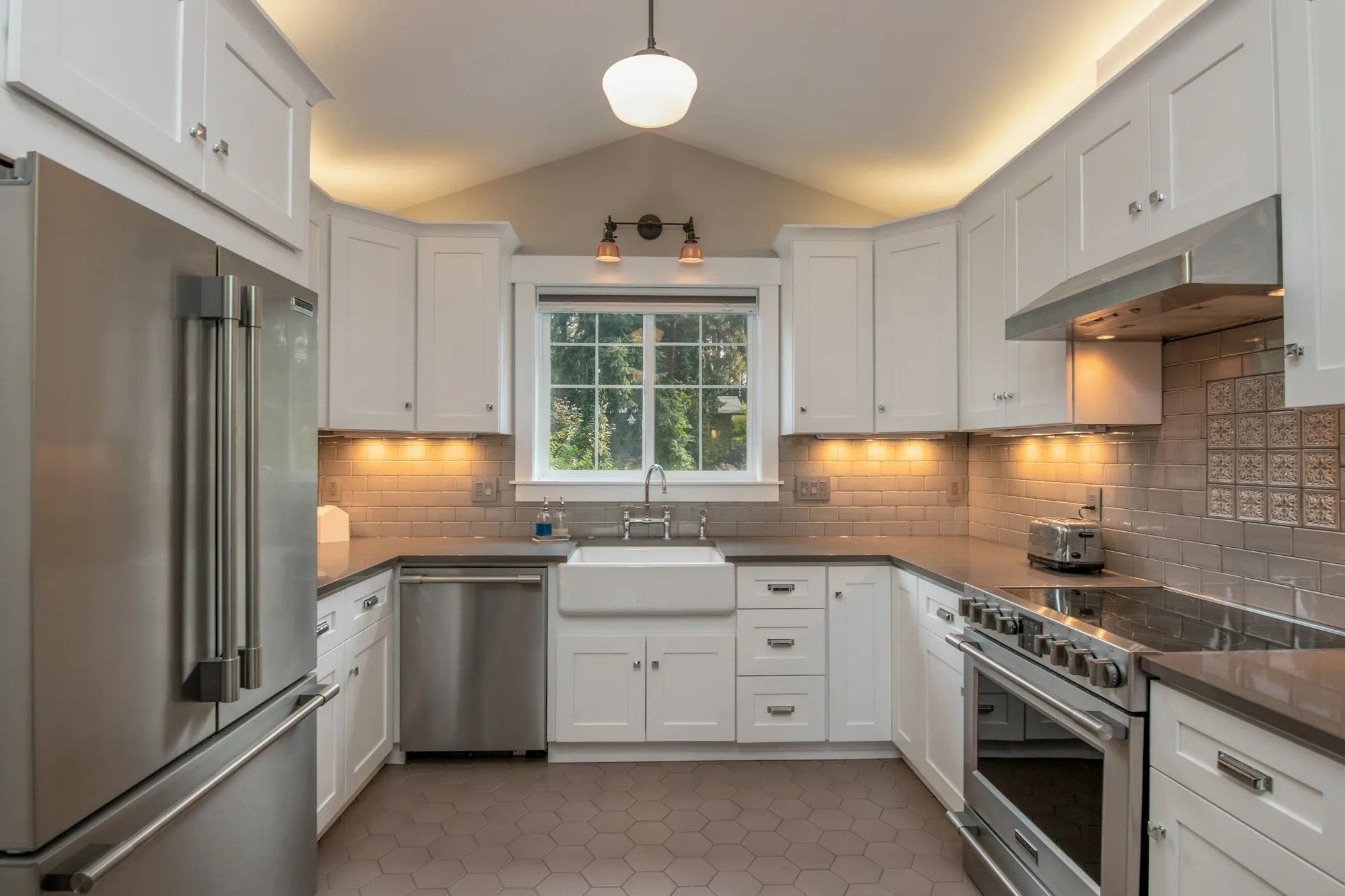 A kitchen with new cabinetry and under-cabinet lighting